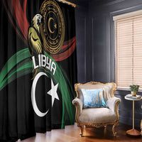 Black window curtain with gold circular emblem, white crescent and star design, red and green rays