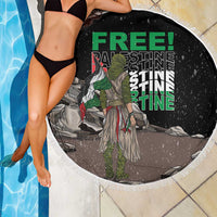 Black round beach blanket with white fringe, warrior artwork with green 'FREE' text