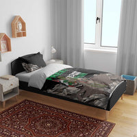 Black bedding set with duvet and two pillowcases, “FREE!” graphic on stone-and-figure design