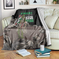 Black throw blanket with green 'FREE' text and detailed protest graphic, draped