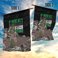 Two black garden flags on poles with 'FREE!' and 'PALESTINE' text over illustrated ruins