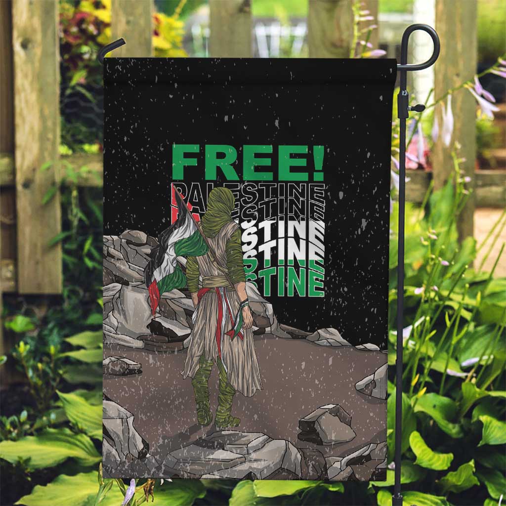 Black garden flag on pole featuring 'FREE!' and 'PALESTINE' text over illustrated scene