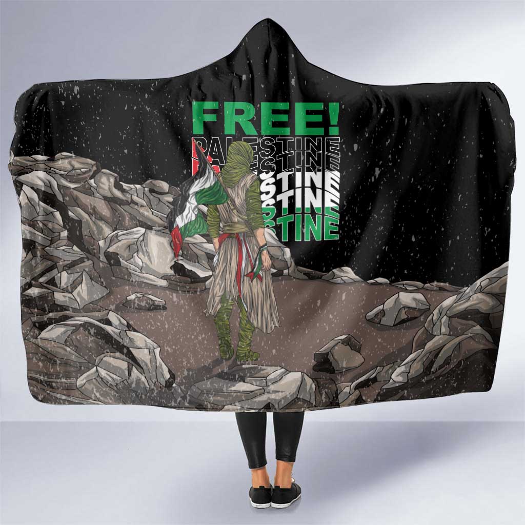 Black hooded blanket with large “FREE!” graphic and illustrated scene on front panel