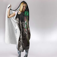 Black hooded blanket draped over shoulders with “FREE!” graphic partially visible