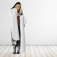 Black hooded blanket with white sherpa lining, worn open like a poncho