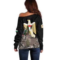 Black off-shoulder sweater with back eagle emblem graphic, long sleeves