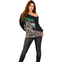 Black off-shoulder sweater with 'FREE' graphic print and eagle figure, front pose