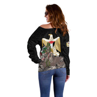 Black off-shoulder sweater with back eagle emblem and Palestinian-flag colors, rear