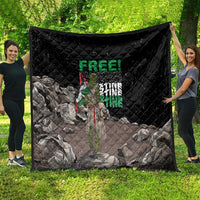 Black quilt with diamond stitching and Palestine-themed graphic, draped on a yard display