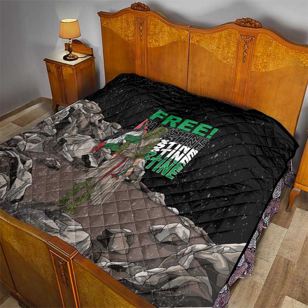 Black quilt with diamond stitching and Palestine-themed graphic on a bed, folded edge visible