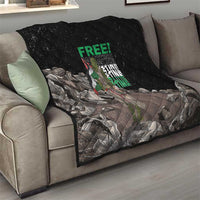 Black quilt with diamond stitching and Palestine-themed graphic on a living room sofa