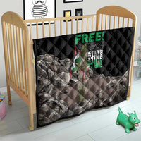 Black quilt with diamond stitching and Palestine-themed graphic in a baby crib