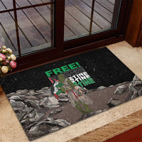 Black rubber doormat with eagle graphic and green “FREE” “PALESTINE” text near door