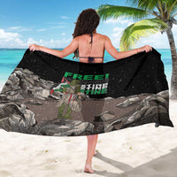 Black sarong draped on beach, FREE! text and eagle over gray stone print
