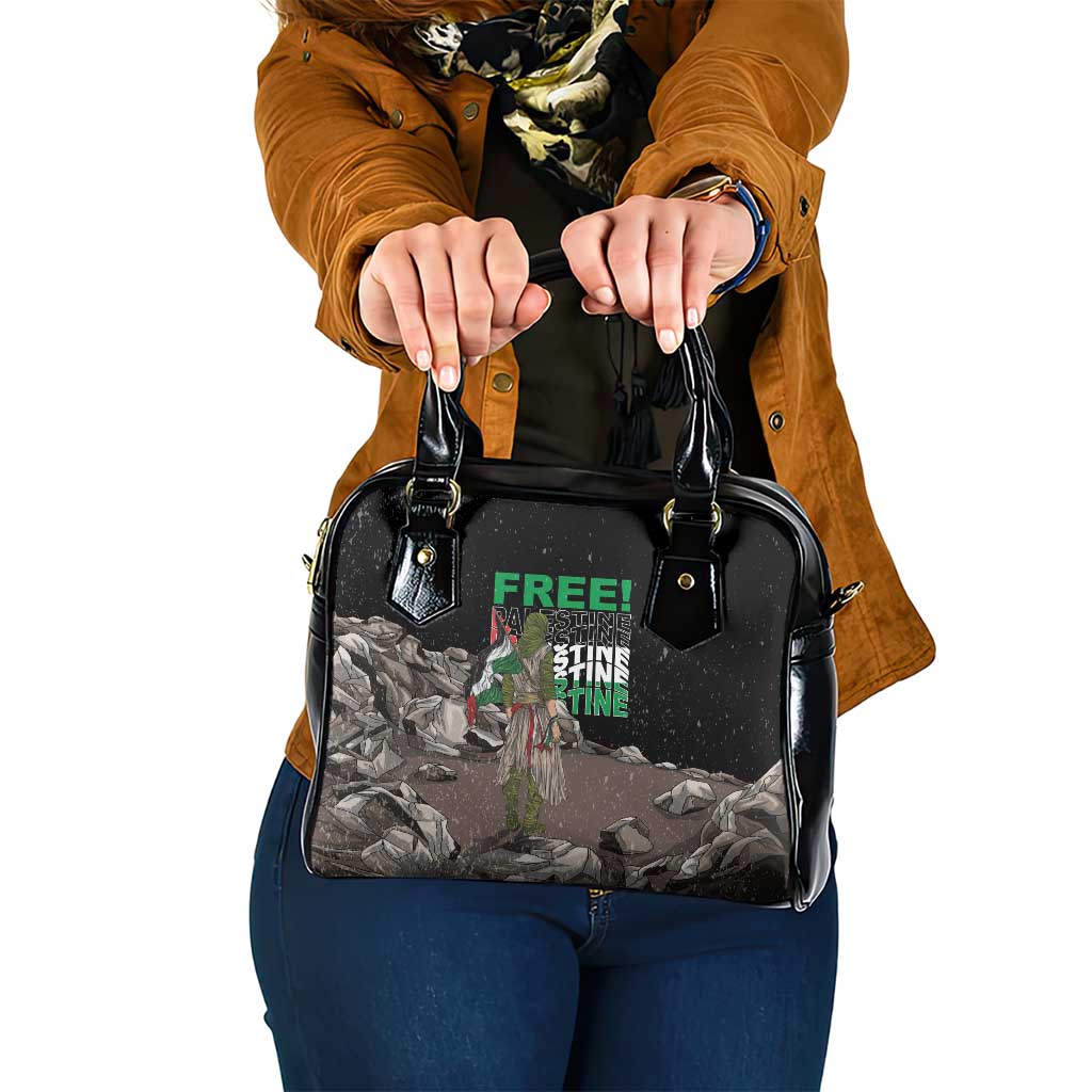 Black shoulder handbag with top handles and crossbody strap, printed front panel