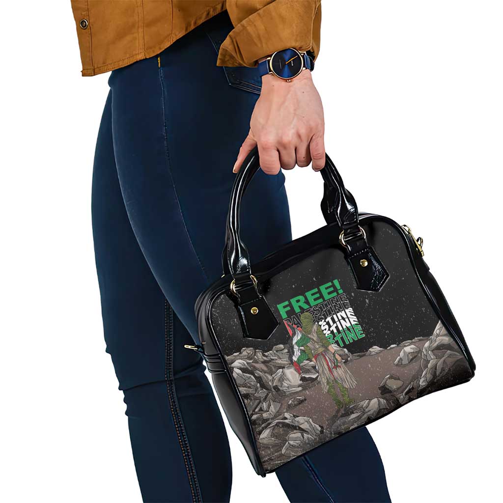 Black shoulder handbag in hand, top handles and printed front panel