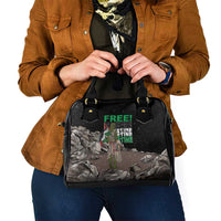 Black shoulder handbag with top handles, front graphic on textured panel