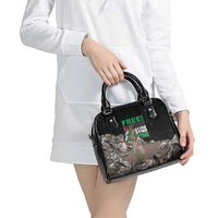 Black shoulder handbag with top handles and front graphic, crossbody strap