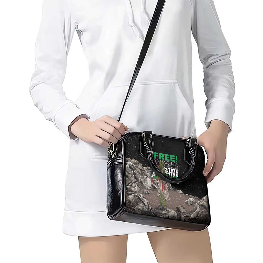 Black shoulder handbag with front graphic and long crossbody strap
