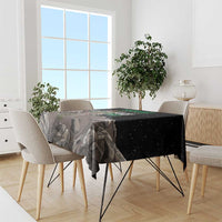 Black tablecloth with eagle and multicolor slogan text over gray landscape print