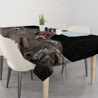 Black tablecloth draped over dining table with eagle and gray landscape graphic