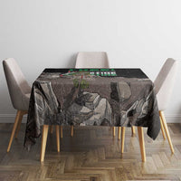 Black tablecloth with eagle graphic and multicolor text, over dining table