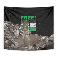 Black tapestry wall hanging, close-up graphic with green “FREE!” text, figure, and rubble rocks
