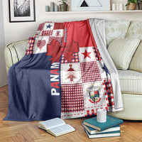 Christmas patchwork blanket with red and navy panels, checkered squares, and large red bow.