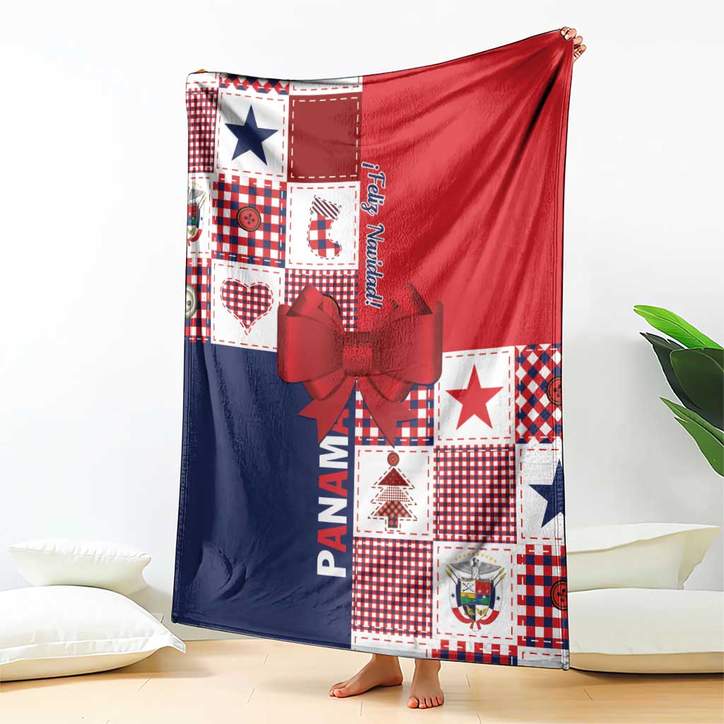 Christmas throw blanket folded with red top, navy bottom, patchwork blocks, and red bow detail.