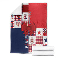 Folded Christmas patchwork blanket in red and navy with checkered blocks, stars, and bow.