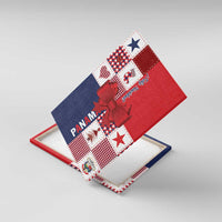 Red Panama Feliz Navidad canvas wall art with plaid patchwork and red bow, shown at an angle