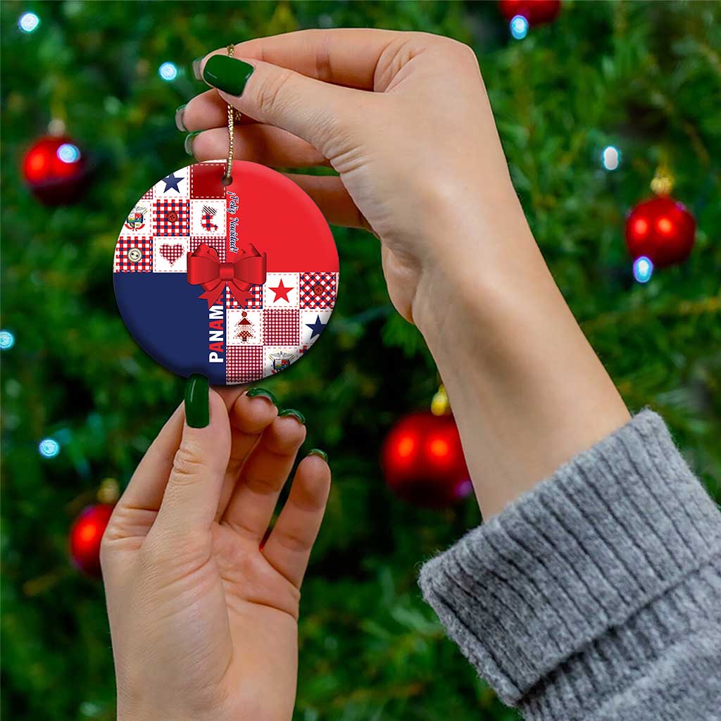 Red and navy ceramic ornament with bow and gold cord, held in hand for display