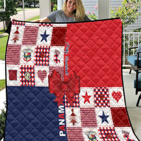 Red, navy and white patchwork Christmas quilt with quilted diamonds and bow applique