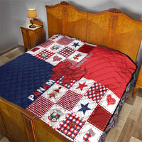 Christmas quilt on bed with red, navy and white patchwork blocks and quilted bow applique