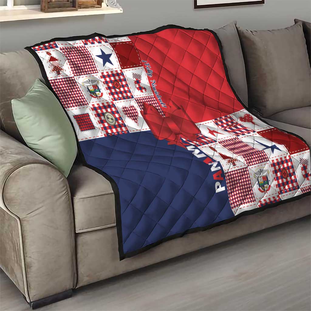 Patchwork Christmas quilt draped on sofa in red, navy and white with bow applique