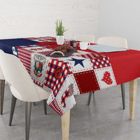 Red, white, and navy patchwork tablecloth with patterned corner drop over table