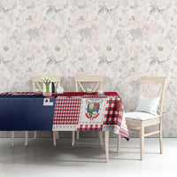 Red, white, and navy patchwork tablecloth with festive block motifs on dining table