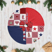 Red and navy Christmas tree skirt with fringe edge and ribbon bow detail