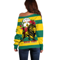 Women’s off-shoulder striped sweater, back view with lion and rose emblem, yellow-green long sleeves
