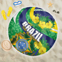Round Brazil beach blanket with Brazil crest, green leaves, and yellow flower print, fringed edge