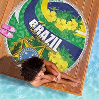 Round beach blanket featuring Brazil crest, green foliage, and yellow floral pattern with white fringe