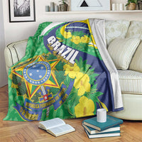 Brazil-themed blanket draped over sofa: green, blue, yellow floral design with emblem