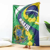 Brazil-themed throw blanket standing on bed with green, blue, yellow floral shield design