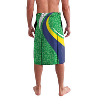Knee-length green patterned shorts with blue and yellow curved stripe panels