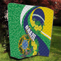 Brazil flag quilt blanket on grass with quilted stitching and colorful emblem center
