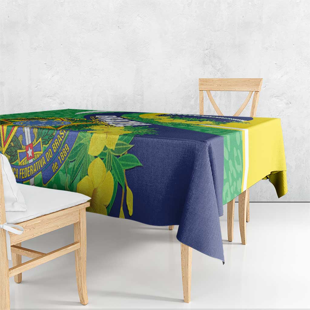 Square tablecloth draped over table corners with green, blue, and yellow leaf-and-flag design.