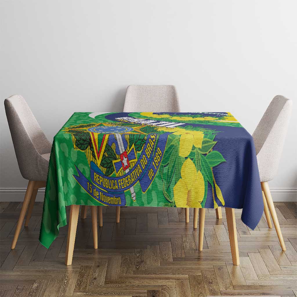 Tablecloth with Brazil flag emblem and yellow flowers over green-and-blue patterned fabric.