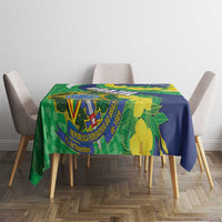 Tablecloth with Brazil flag emblem and yellow flowers over green-and-blue patterned fabric.