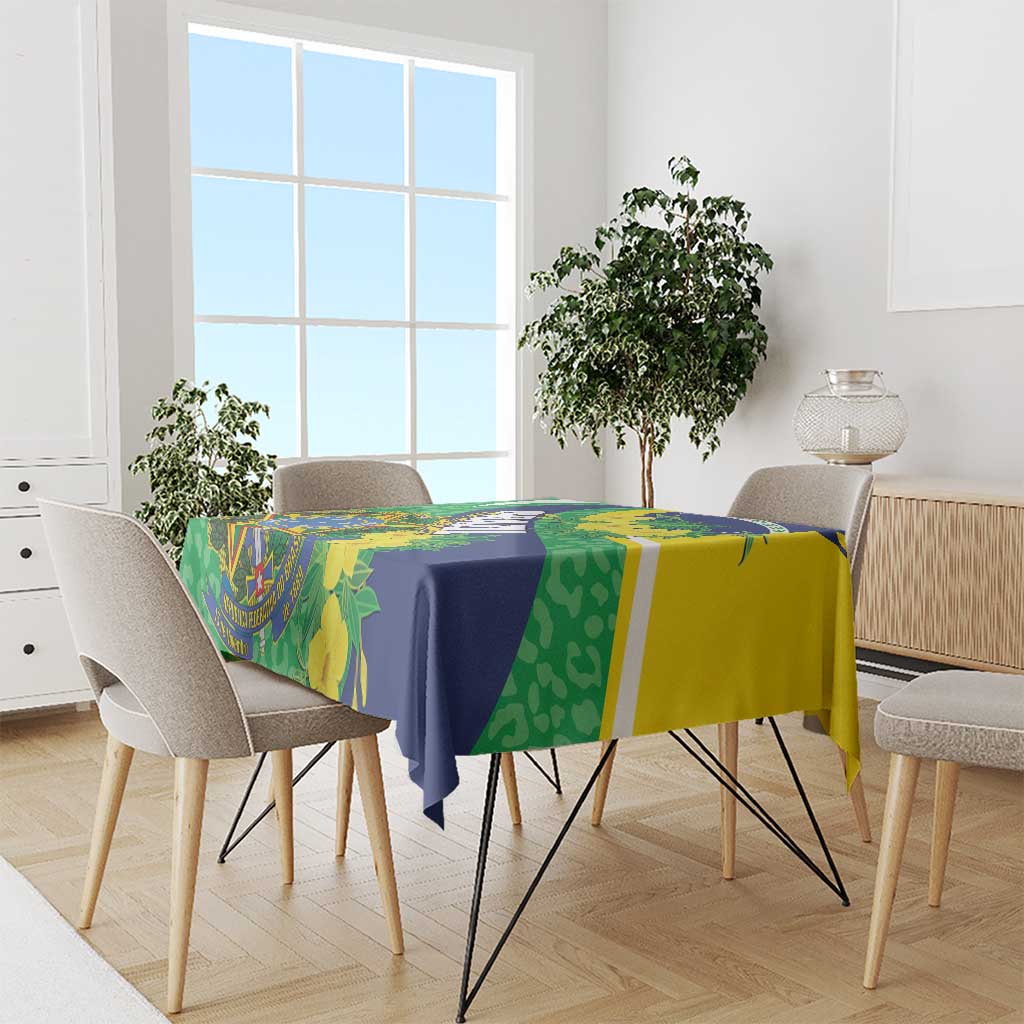 Tablecloth with green, blue, and yellow Brazil-themed flag and foliage pattern on dining table.