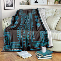 Traditional geometric pattern blanket with dark base and bright blue motifs and border